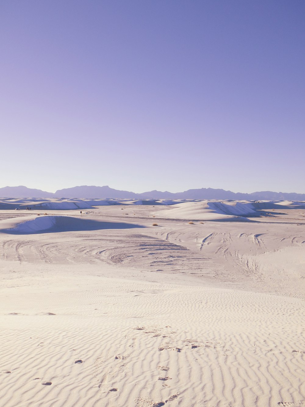 A sand dune under a blue sky photo – Free Nature Image on Unsplash