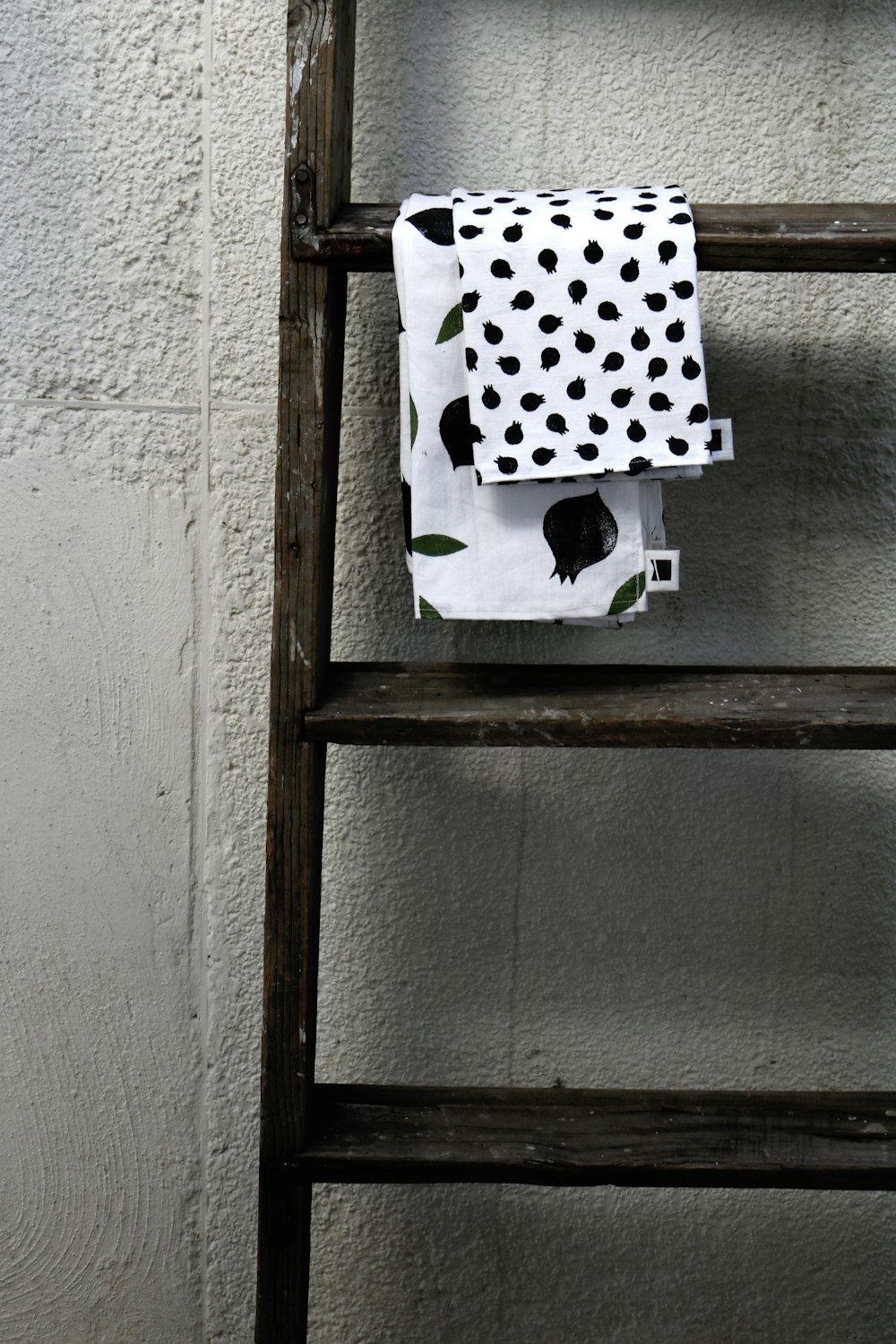 white and black polka dot textile on brown wooden frame