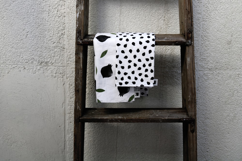 white and black polka dot textile on brown wooden window