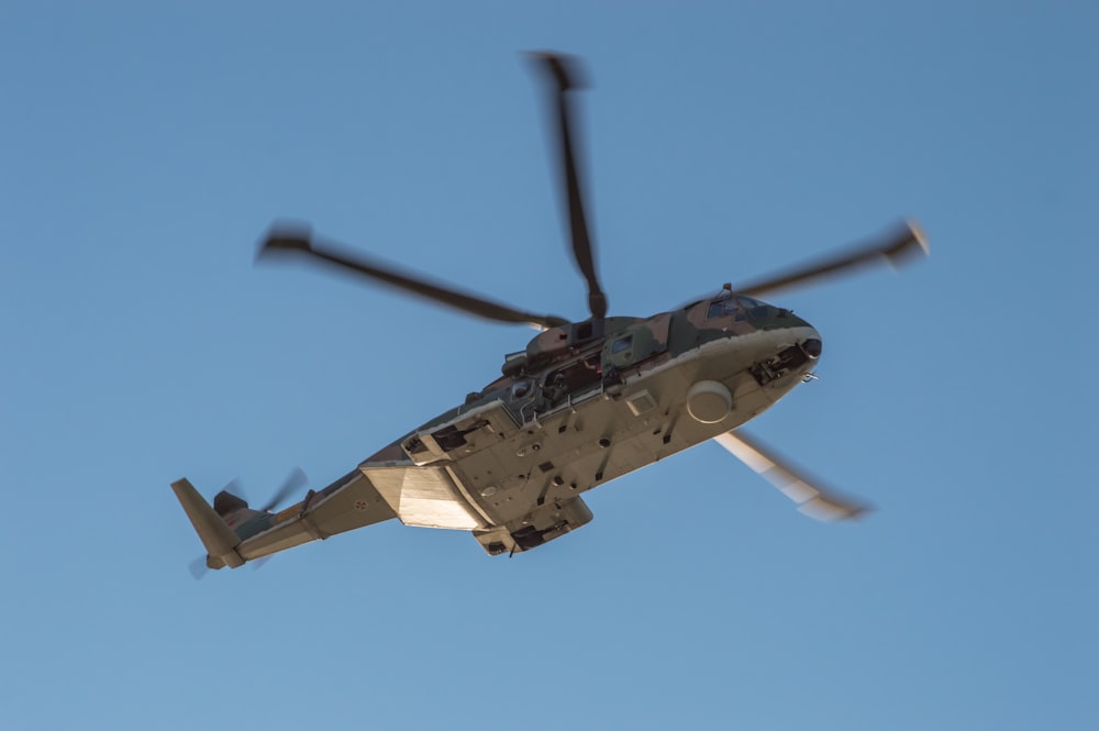 gray helicopter flying in the sky during daytime