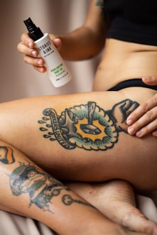 person with blue and black tattoo on right leg
