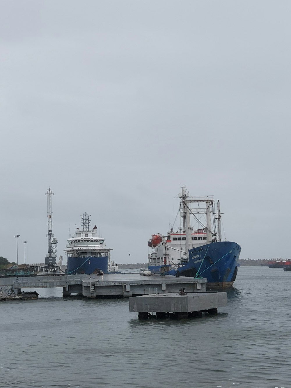 blue and red ship on sea during daytime