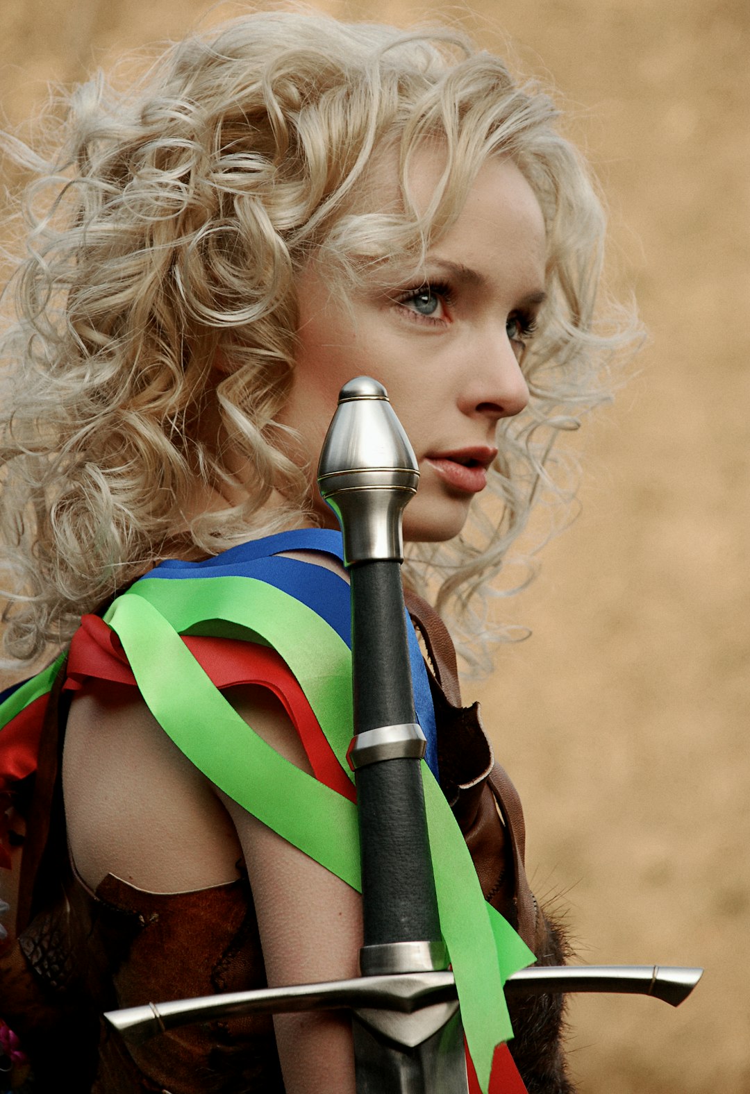 woman in brown and green coat holding black and silver microphone