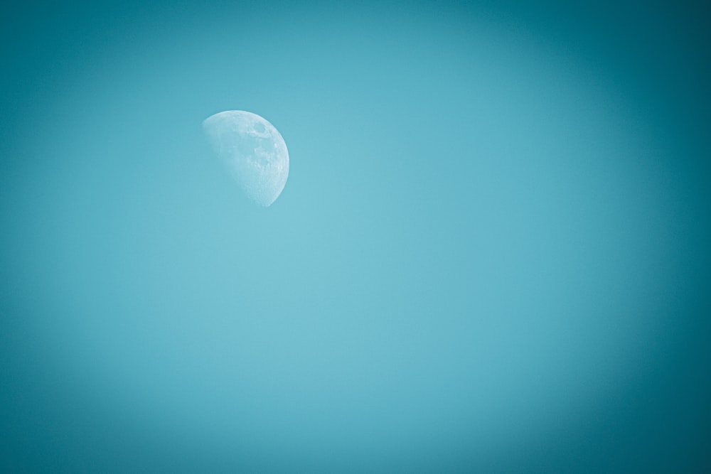 white moon in blue sky