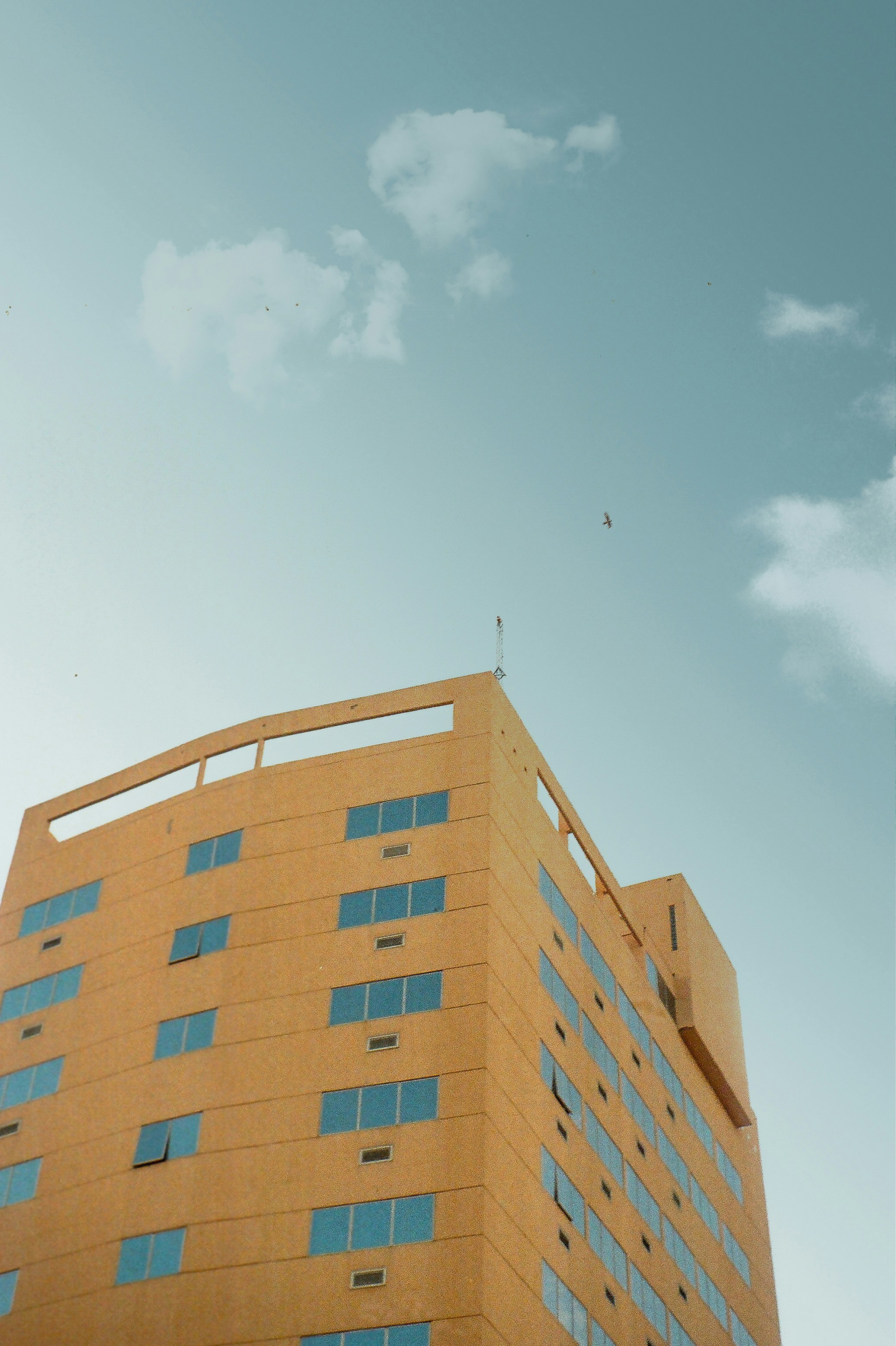 brown concrete building under blue sky during daytime