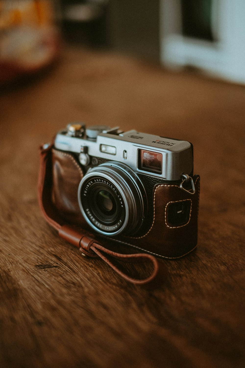 schwarz-silberne Kamera auf braunem Holztisch