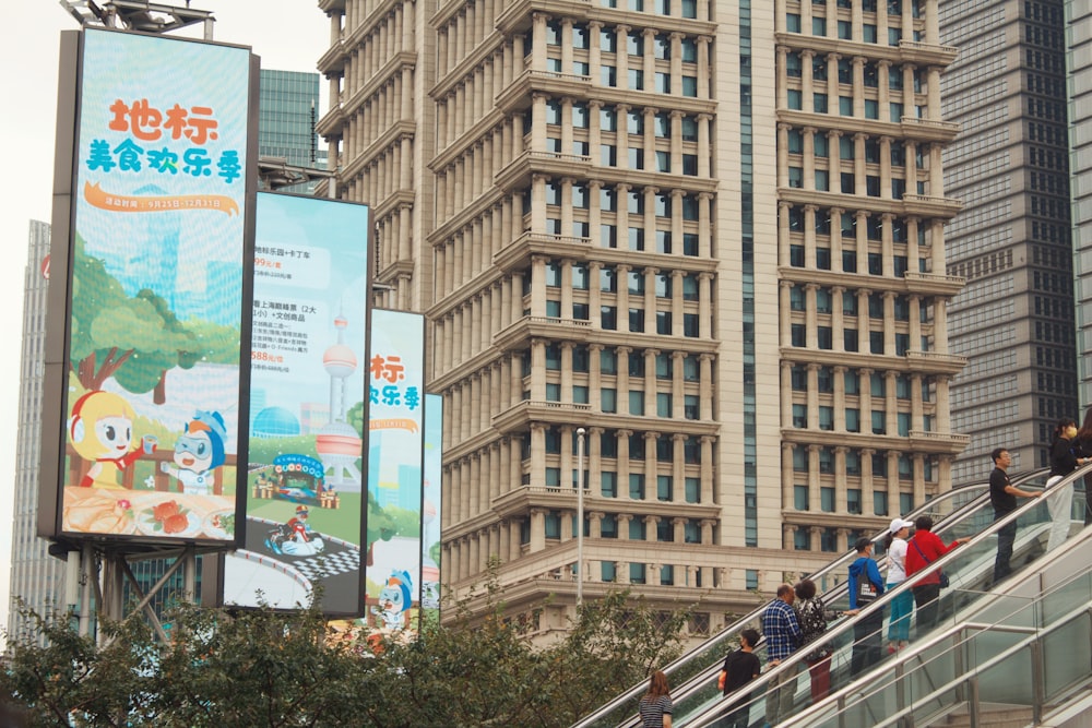 people walking on sidewalk near high rise building during daytime