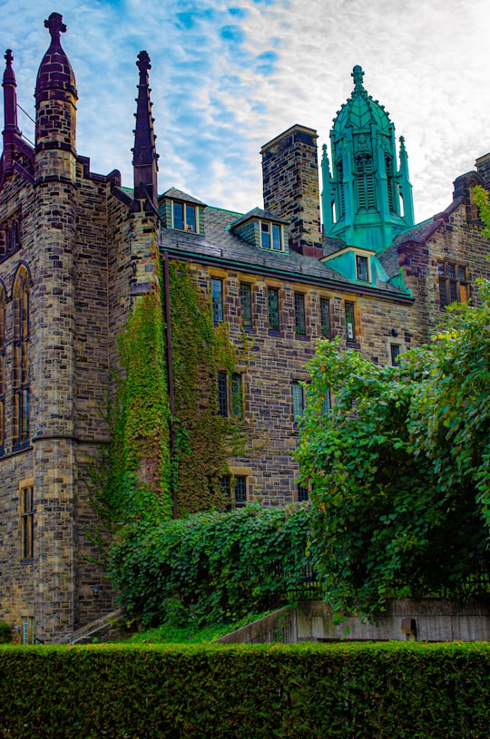 brown brick building with green plants in University of Toronto - St. George Campus Canada