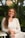 woman in white long sleeve shirt smiling