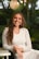 woman in white long sleeve shirt smiling