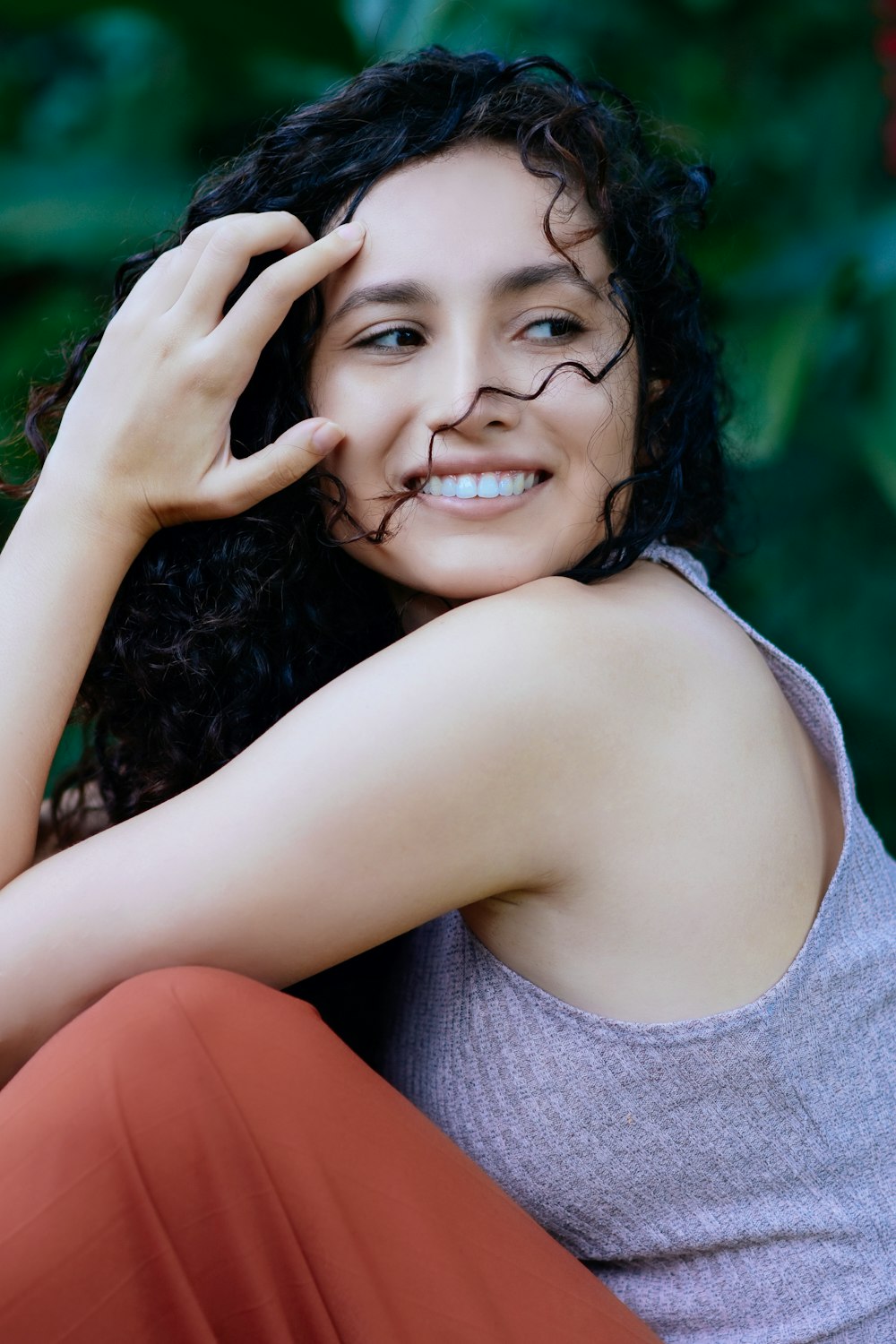 woman in gray tank top smiling