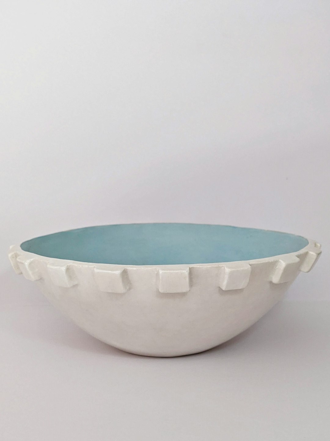 green ceramic bowl on white table