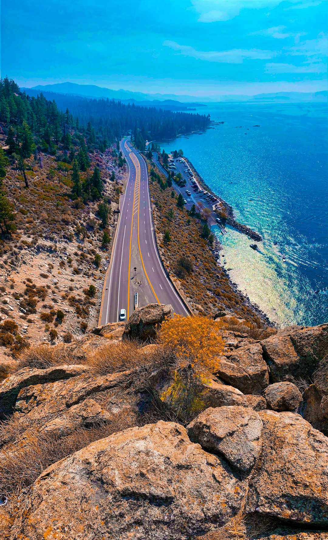 aerial view of road near body of water during daytime