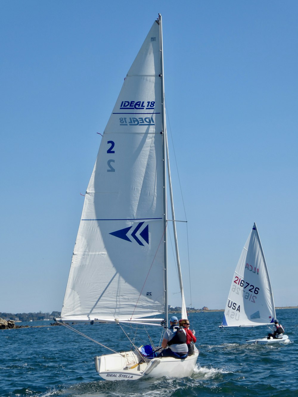 white sail boat on sea during daytime