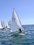 2 white sail boats on sea during daytime