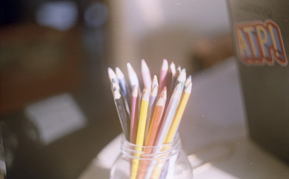 coloring pencils in clear glass jar