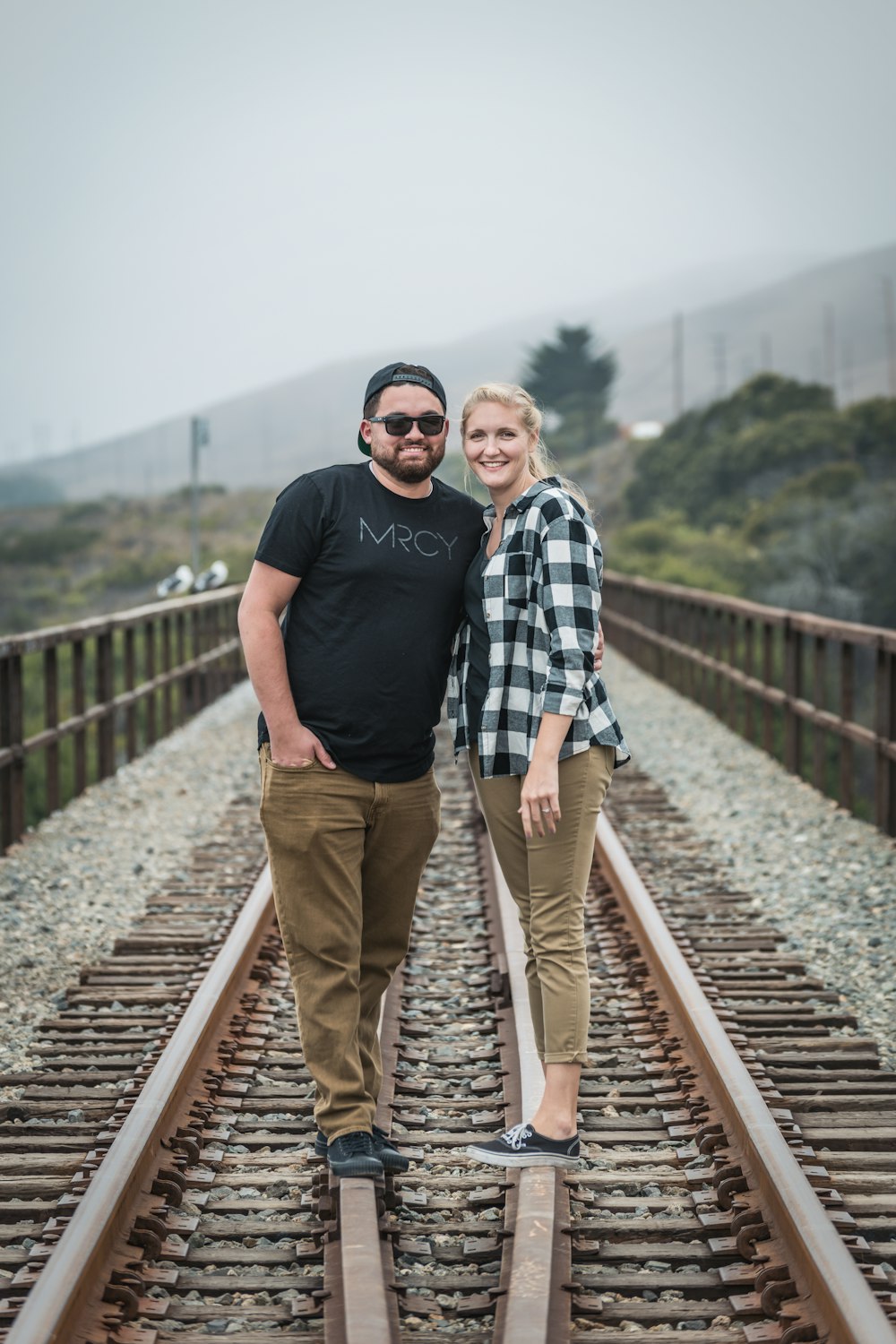 man in black crew neck t-shirt standing beside man in blue crew neck t-shirt