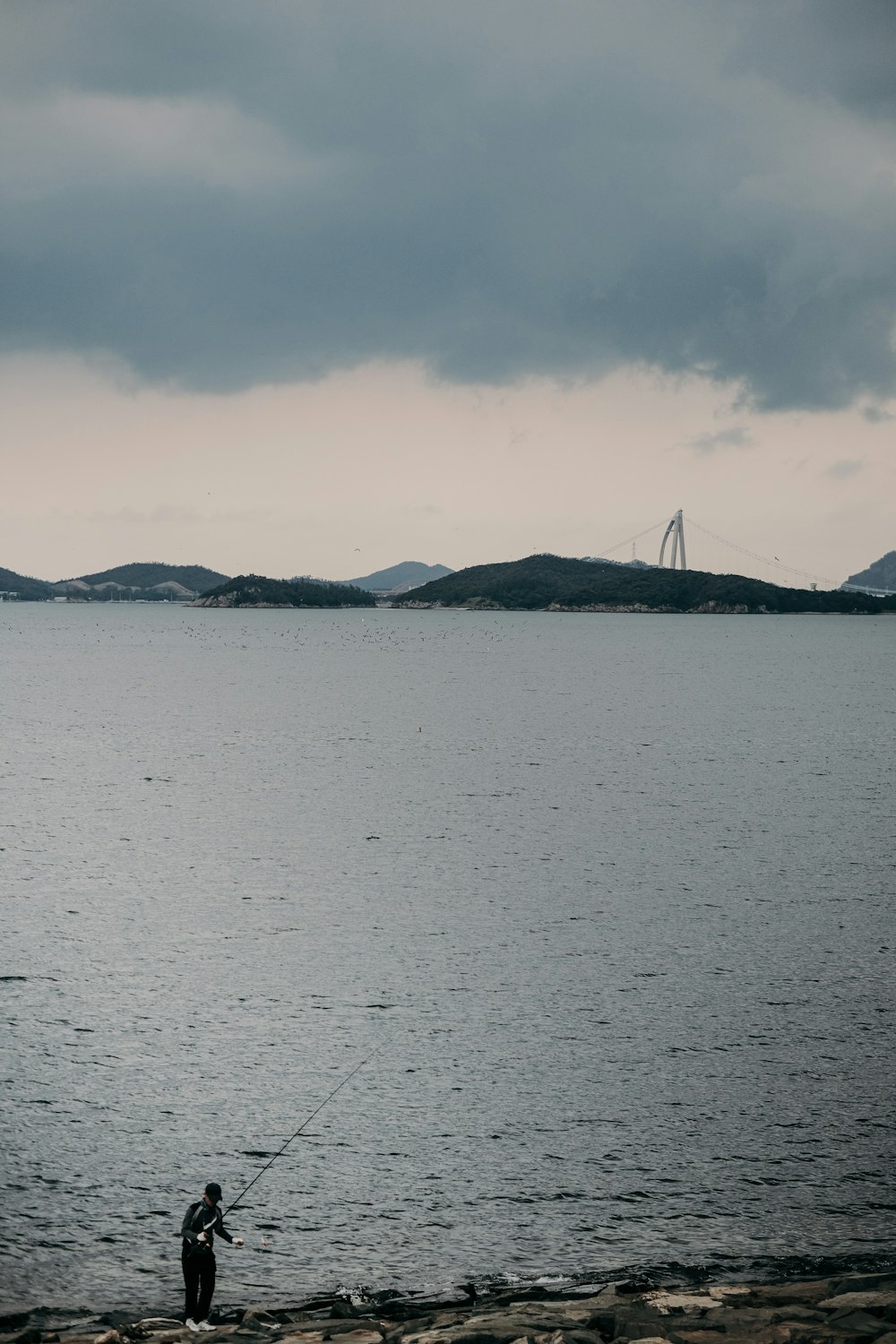 body of water near mountain during daytime