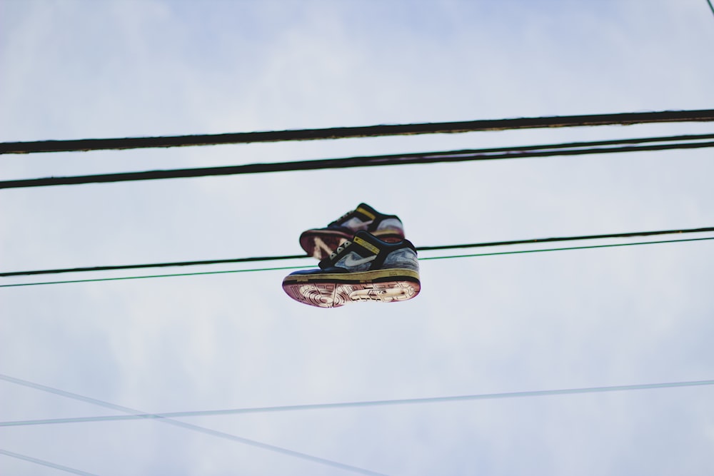 black and green hiking shoes on black electric wire