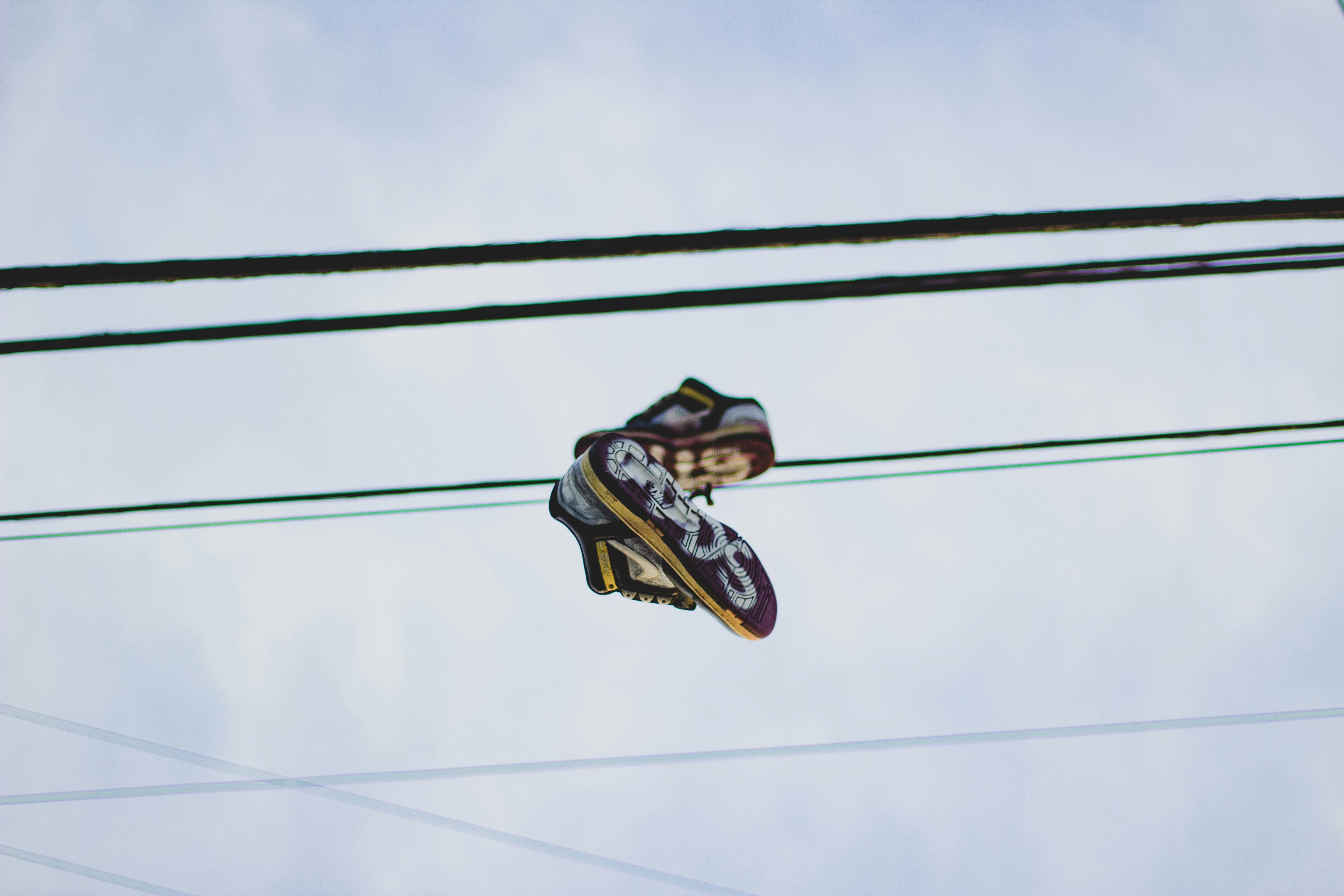 black and white nike sneakers on black cable wire