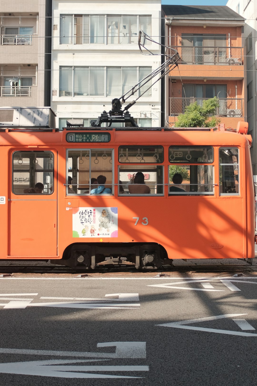 orange and white tram on road during daytime