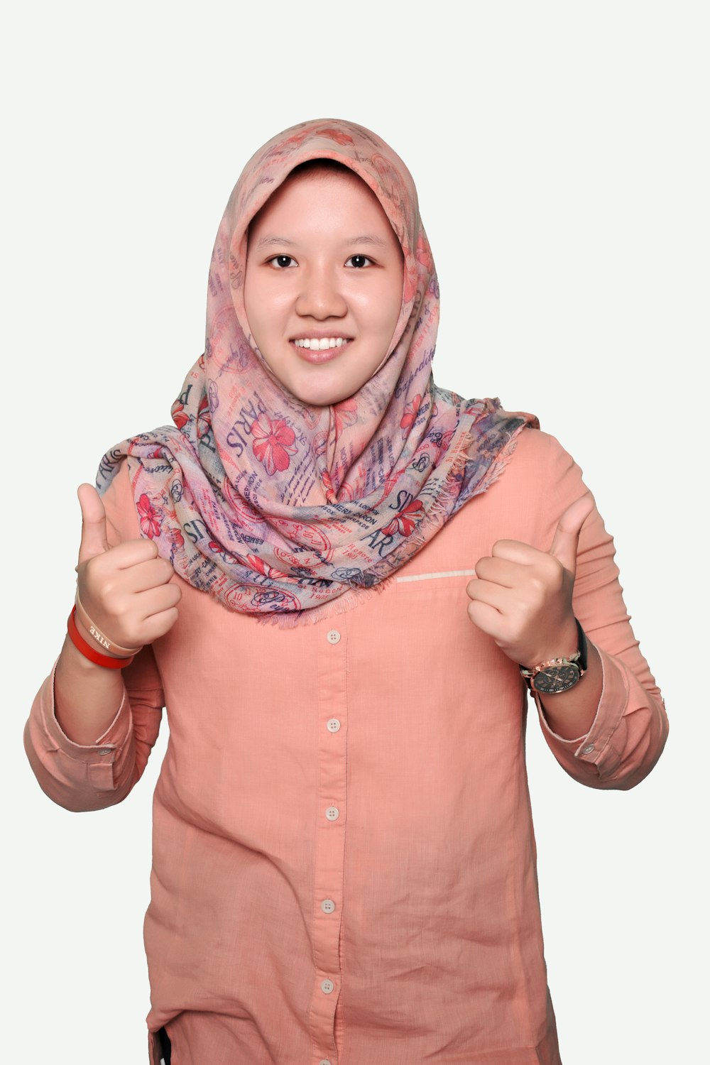 woman in pink button up shirt wearing purple and white hijab