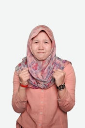 woman in pink hijab and pink button up long sleeve shirt