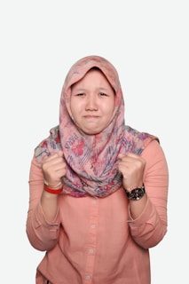 woman in pink hijab and pink button up long sleeve shirt