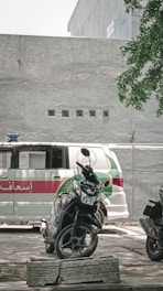 A Speedie Courier vehicle parked outside a hospital emergency entrance.