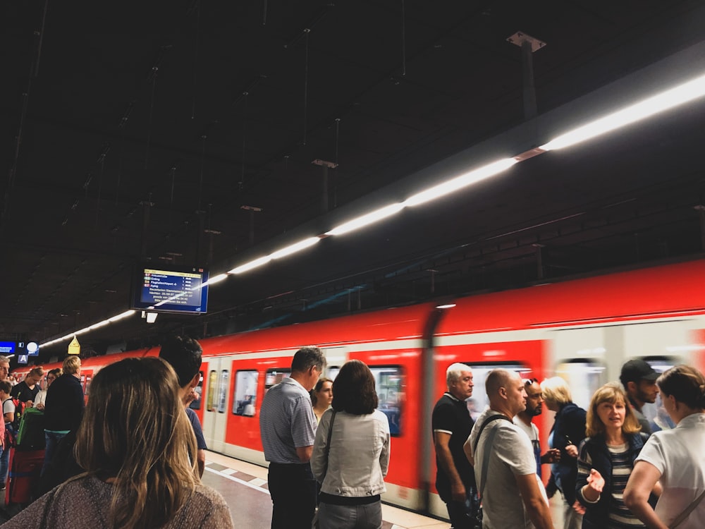 people standing on train station