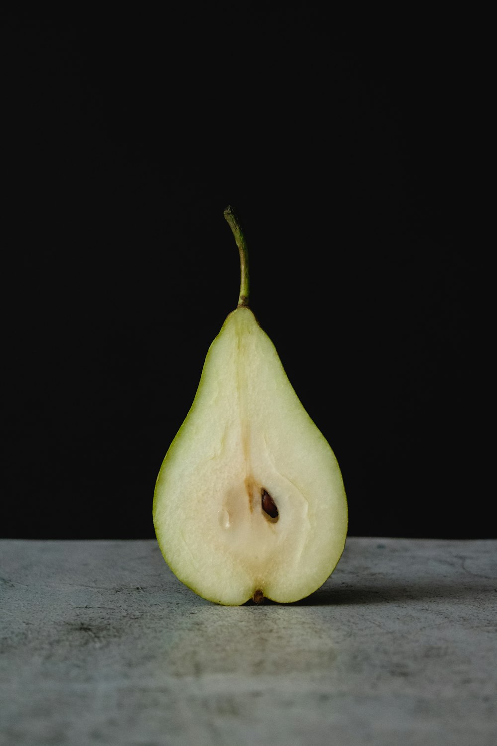 green fruit on gray wooden table