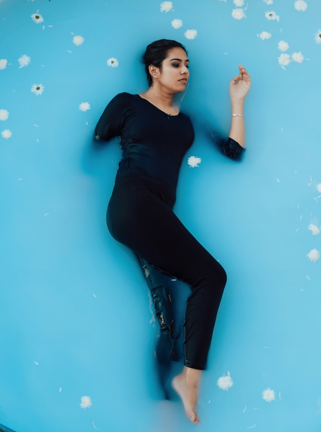 woman in black long sleeve shirt and blue denim jeans