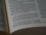A close-up view of an open book showing a biblical text. The passage features quotes from Balak son of Zippor and Balaam.