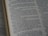 An open page of a book with closely spaced text. The page appears to be from a religious or historical text, featuring paragraphs and numbered verses.