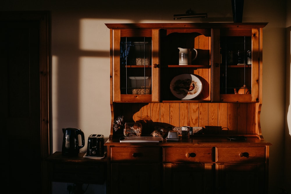 black and silver coffee maker on brown wooden table