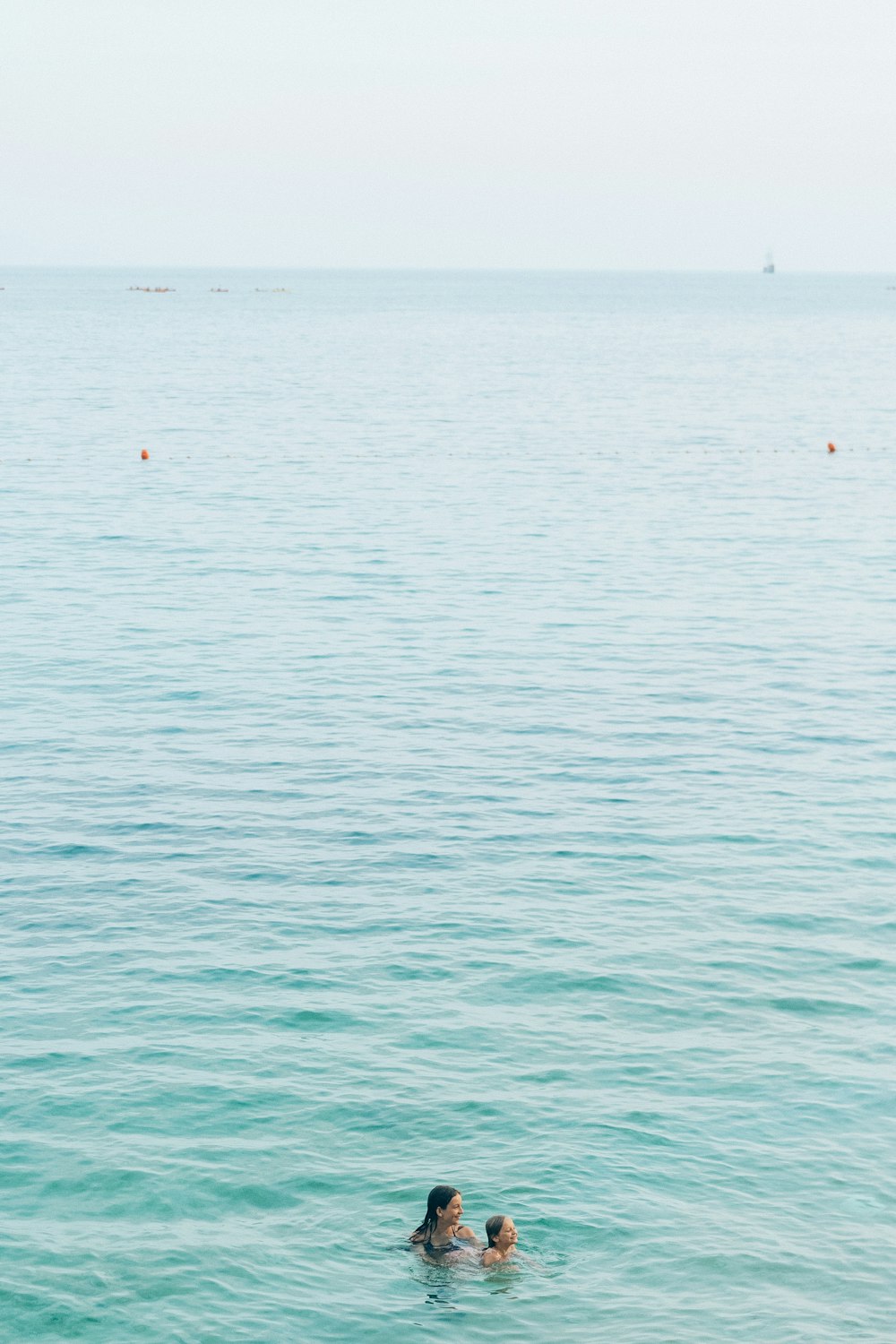 person in red shirt riding on boat on sea during daytime