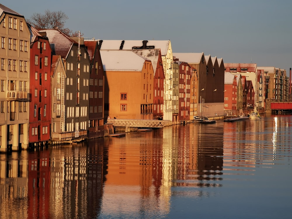 brown and red concrete building beside body of water during daytime