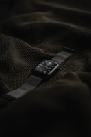 Modern smartwatch displaying notifications with a green highlight on a black surface