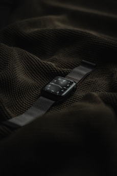 Modern smartwatch displaying notifications with a green highlight on a black surface