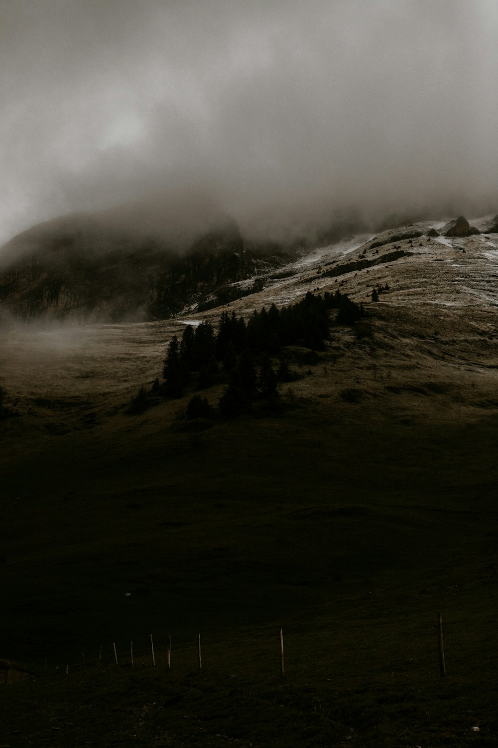 grayscale photo of mountain with fog