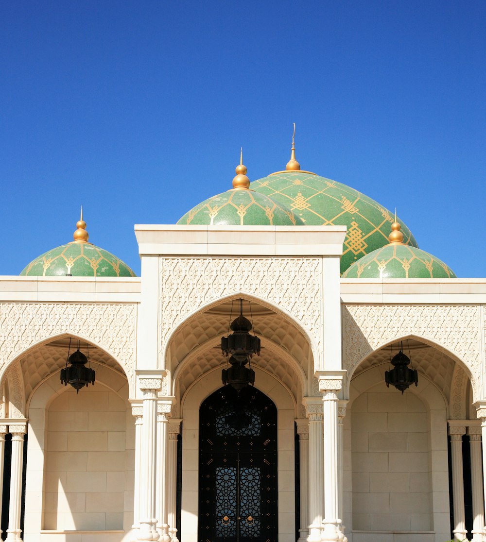 white and green dome building under blue sky during daytime