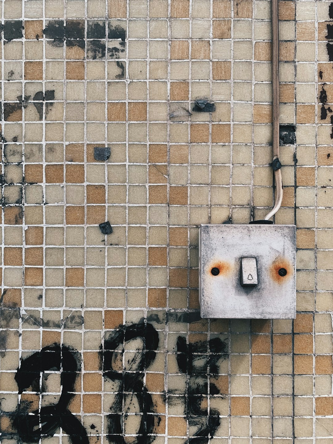 white wall mounted switch on brown brick wall