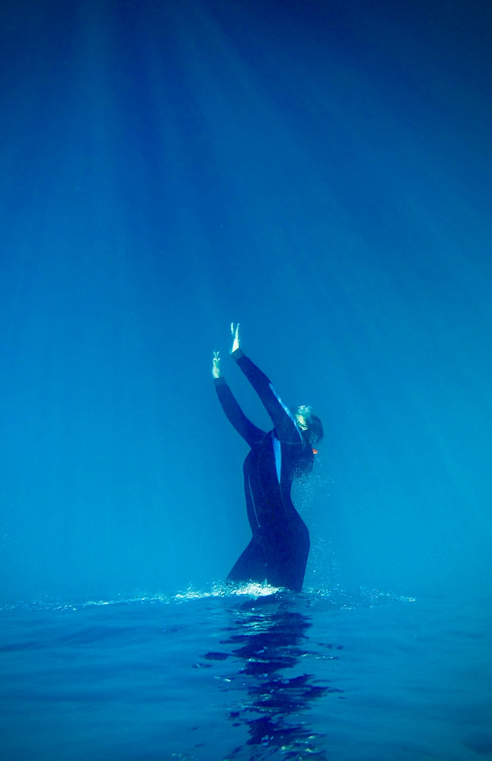 woman in black wetsuit in water