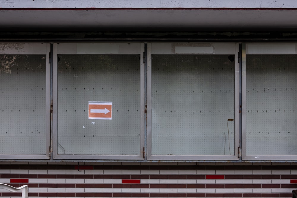 white and red arrow sign on gray steel door