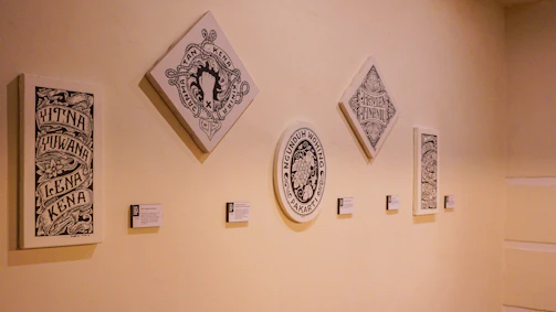 A series of original paintings arranged to emphasize their unique limited edition numbers.