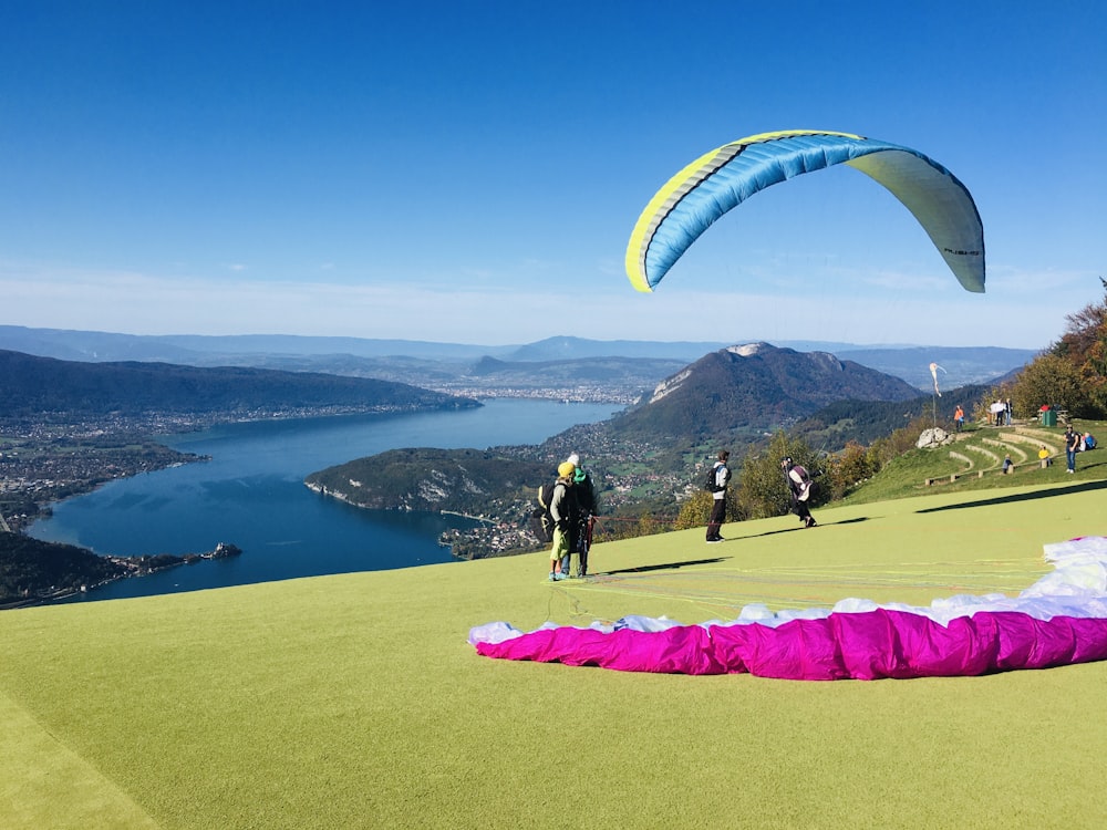 man in black shirt and black pants holding pink and yellow parachute