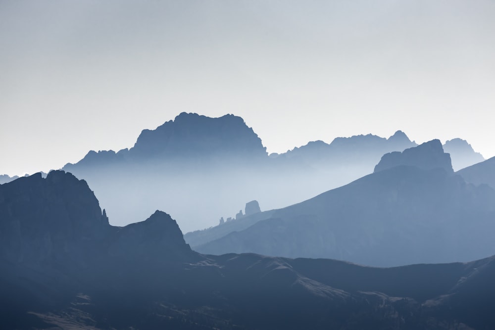 silhouette of mountains during foggy day