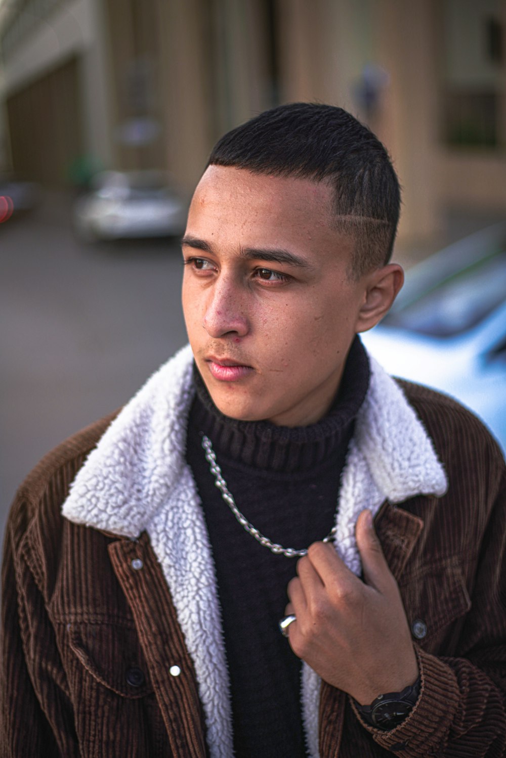 man in brown and white plaid button up shirt wearing white scarf