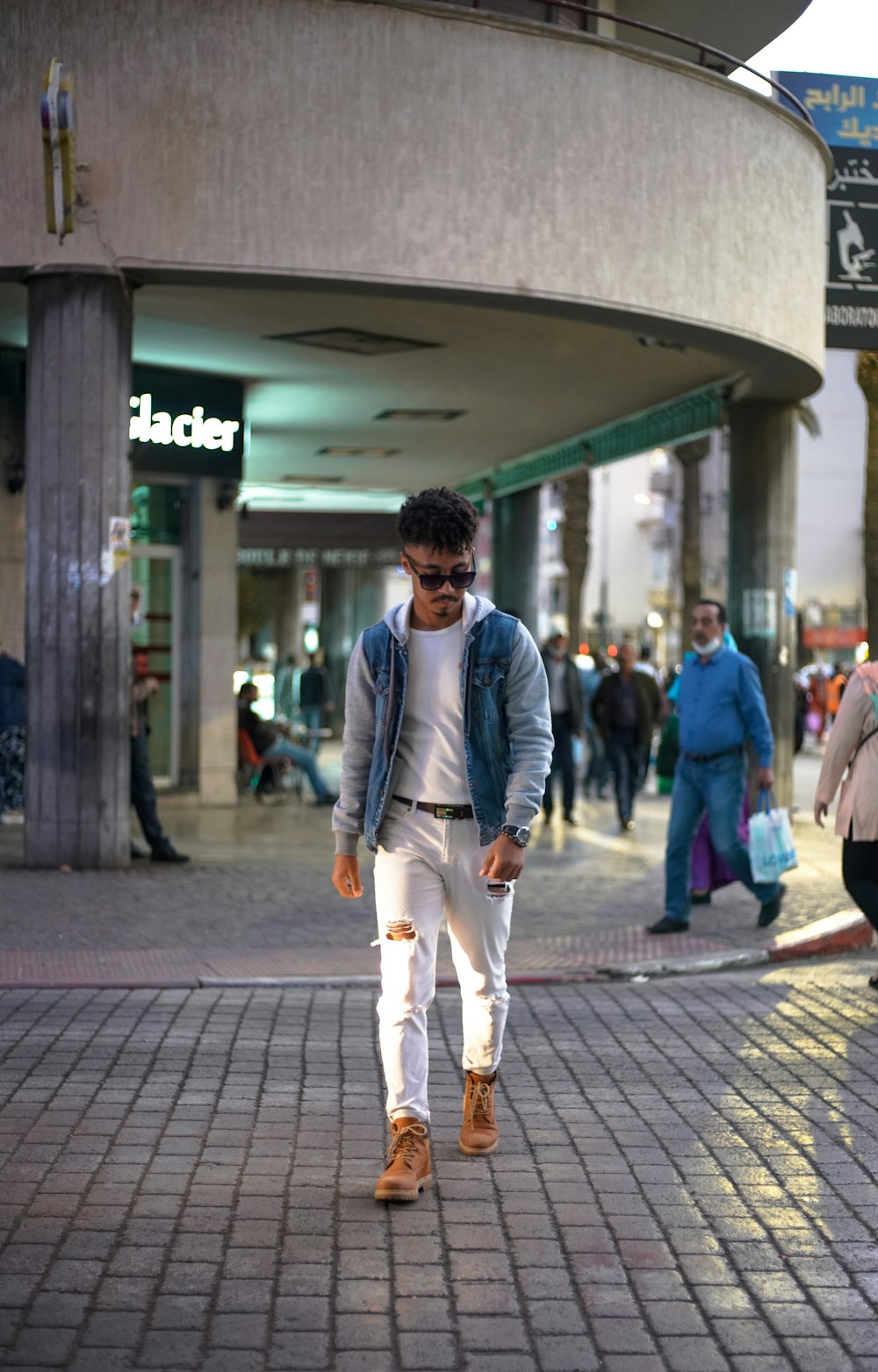 man in gray suit walking on sidewalk during daytime