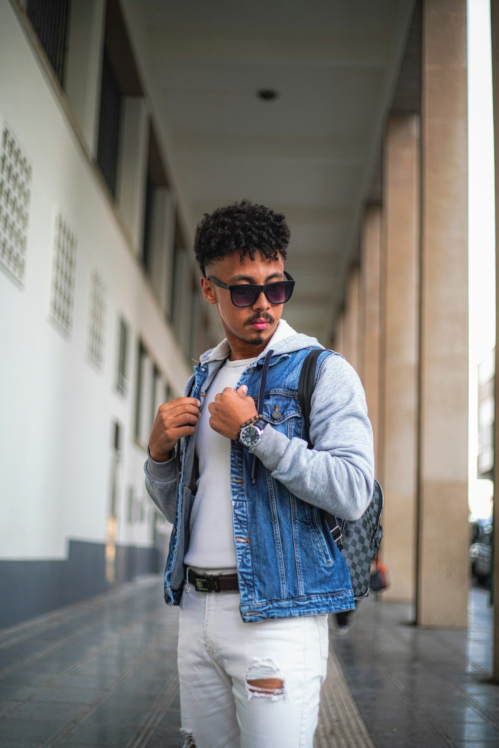 man in blue denim button up jacket wearing black sunglasses